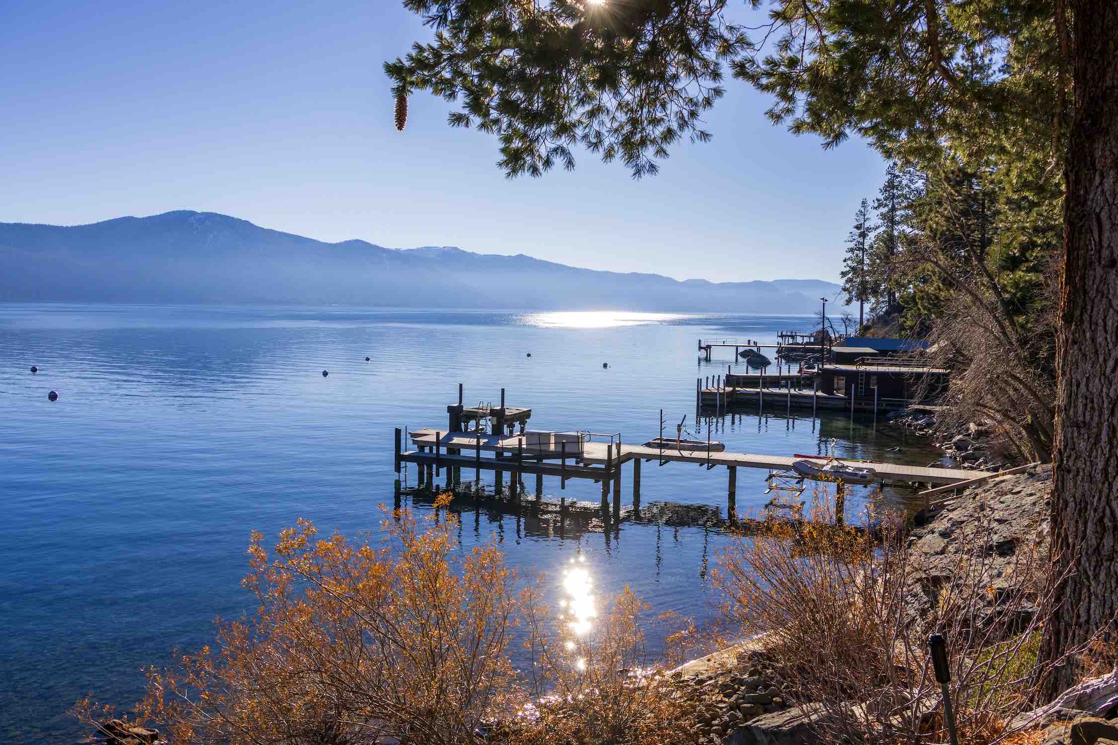 Large lakefront lodge at Lake Tahoe with mountain views and private dock
