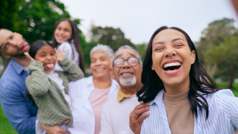 A young woman laughing with her multi-generational family