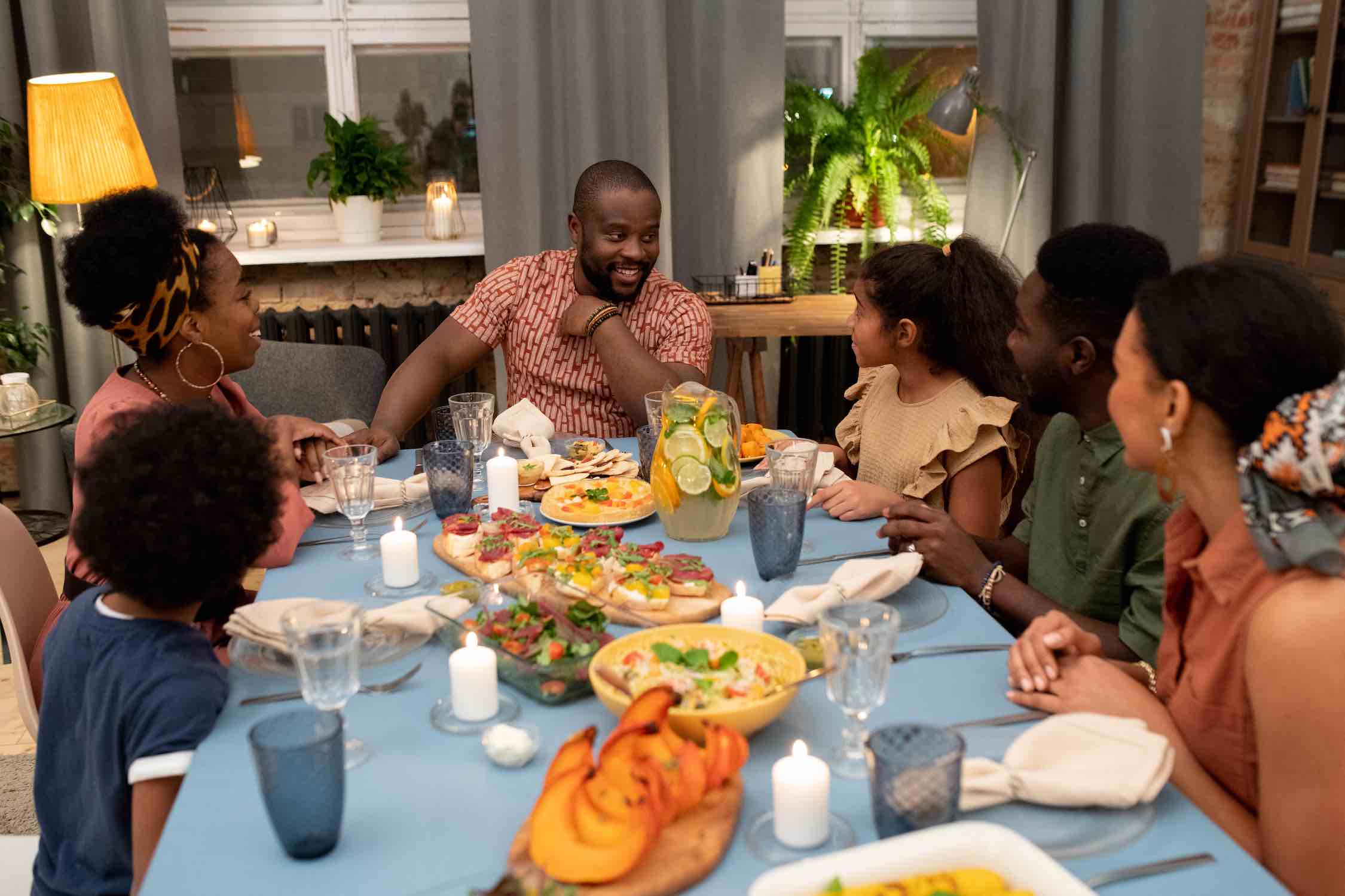 Large family group seated at a long table for a Lowcountry seafood dinner